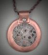 "Wheels of Time" copper and steel pendant 1.50 x 1.75”, comes with a 20” chain.