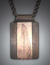 Pendant - Bronze leaf inlay on White Satin blackened with patina; 1 ½ x 1