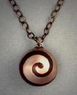 Spiral;  Copper and Bronze spiral ball pendant measuring ¾ dia. and hangs on a bronze 18 to 23 adjustable length chain.