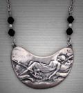 "Aglow"; Art Nouveau-like, White Satin pendant with woman resting in a hammock. Measures 2 1/2" w x 1 1/4 h. $175