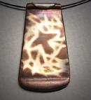 “Soaring”;  Copper pendant with Bronze inlay of a bird flying. 1"w x 2"h and hangs on  Memory wire.