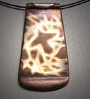 Soaring;  Copper pendant with Bronze inlay of a bird flying. 1"w x 2"h and hangs on  Memory wire.