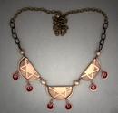 Necklace of 3 bronze half moon shapes embossed with stars (ea. 1 ½ wide) and red resin spiral dangles below, and each is separated by a solid bronze bead. Hangs on an adjustable 18  21 antiqued bronze chain.  (see matching earrings)