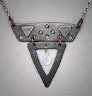 Steel Sm. V Pendant ; L=  1 3/4    W= 1 7/8;  Hand sculpted steel pendant.   Triangular shapes, 2 piece steel within which hangs a 5x7mm Fire Moonstone briolette gemstone.  Hangs on a 20 chain.