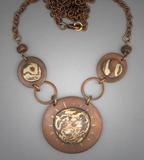 3 Disc M.G. Necklace; Dia.= 1 ¾;   Hand sculpted copper and bronze Mokume Gane 3 piece necklace; aprox. 5 wide.  Center piece is largest flanked by 2 smaller MG circles and 2 antiqued copper beads, with a 27 ½ copper chain.