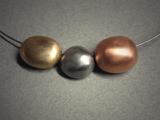 3 hollow beads; necklace; 1 bronze, 1 steel & 1 copper together measuring 2 ½w x ½h.