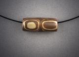 Mokume Gane Double Bead; copper and bronze bead, ½h x 1w, hanging on Memory Wire.