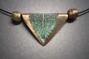 Bronze triangular shaped pendant of a leaf with a green patina, sitting between 2 bronze beads. Leaf measures ¾w x 7/8w and hangs on Memory Wire.